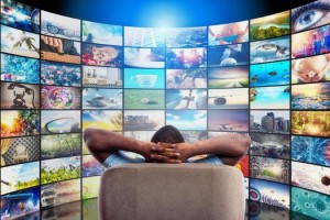 man has fun watching a film and relaxing on a armchair concept of entertainment and streaming tv pho